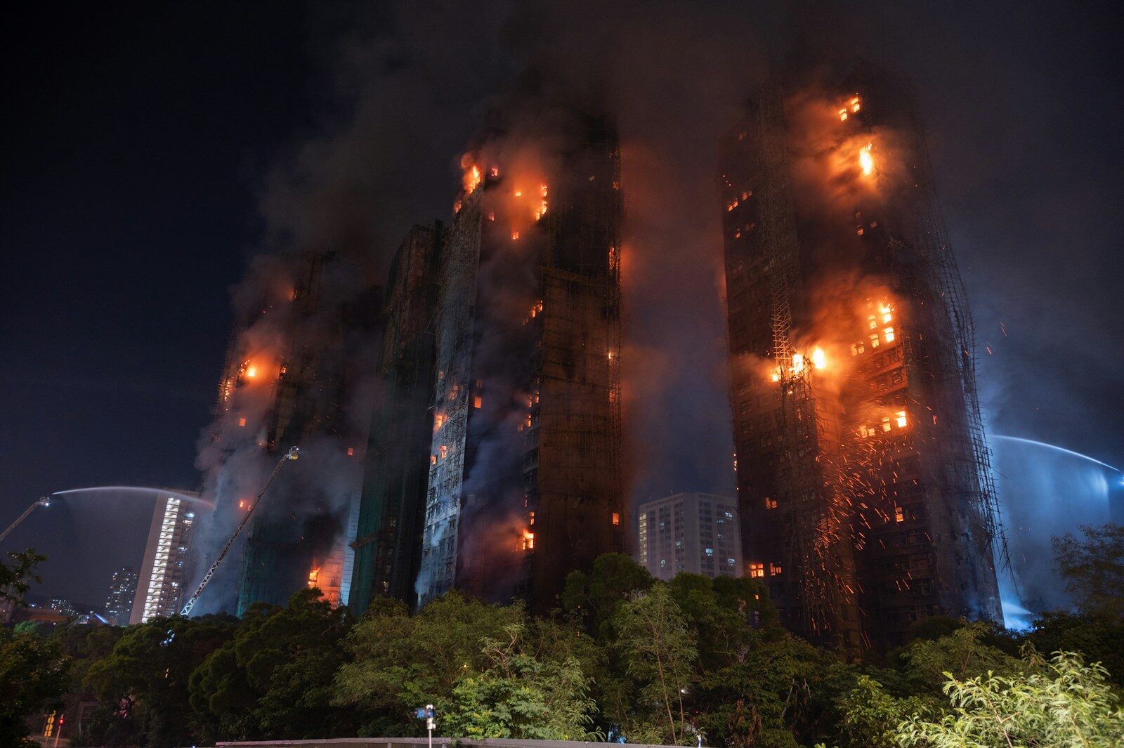 Tall buildings engulfed in flames at night